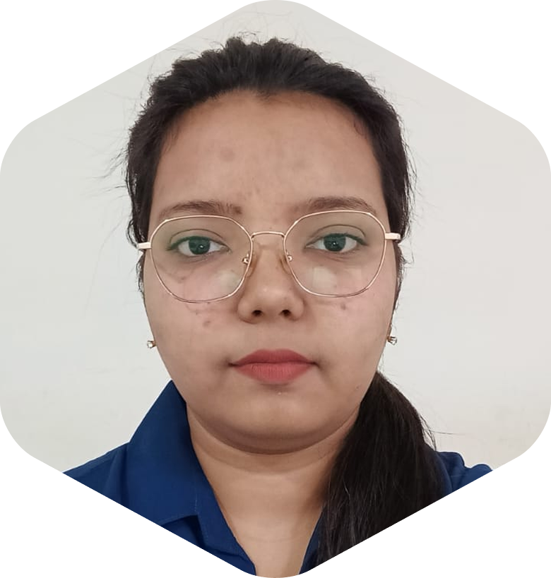 Portrait of a young woman with round glasses, dark hair in a ponytail, wearing a blue collared shirt, facing the camera with a neutral expression.